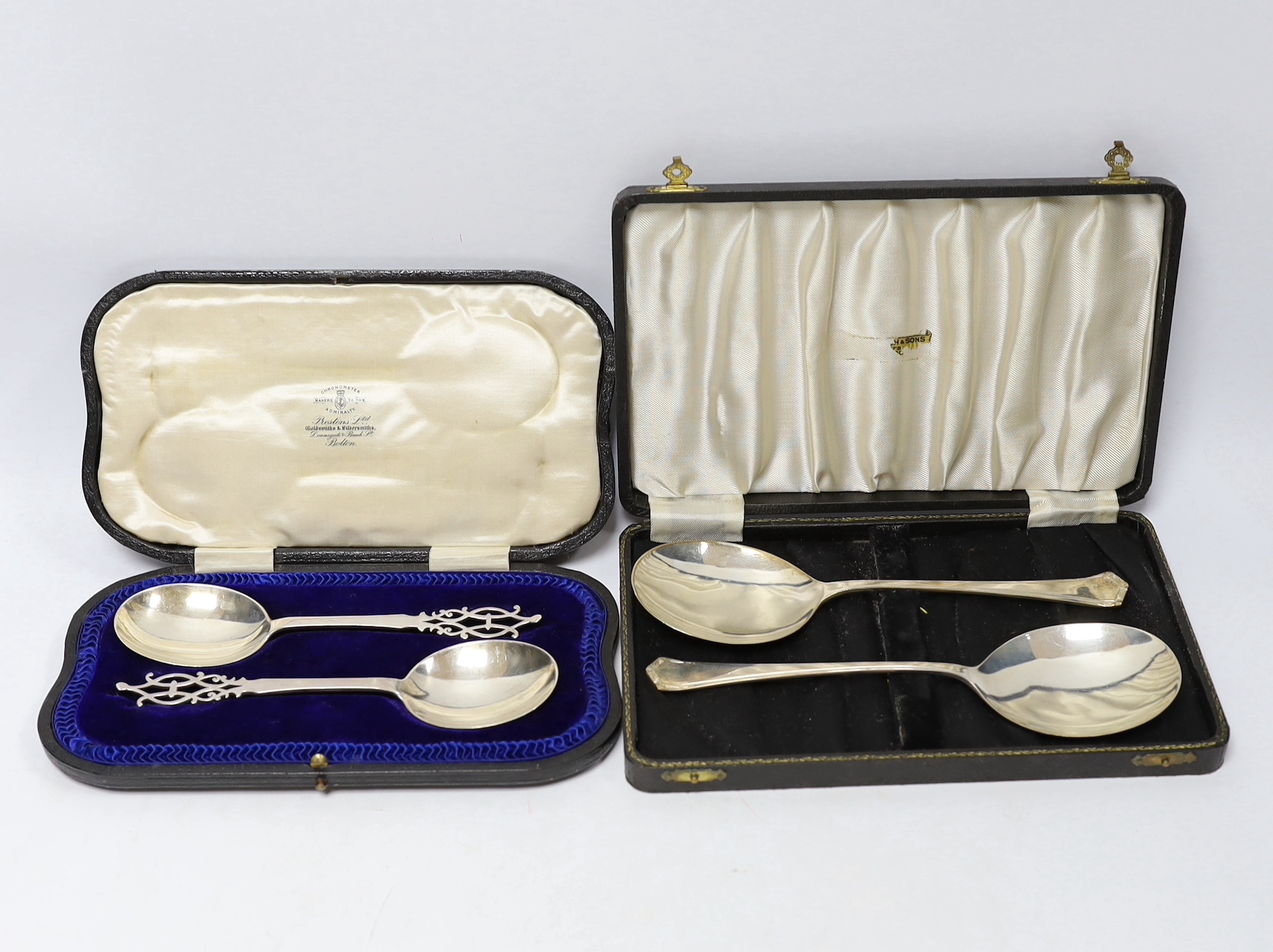 A cased pair of Edwardian silver serving spoons with pierced terminals, Josiah Williams & Co, London, 1907, 17.9cm and one other cased pair of silver servers.
